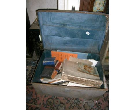 A metal trunk containing books