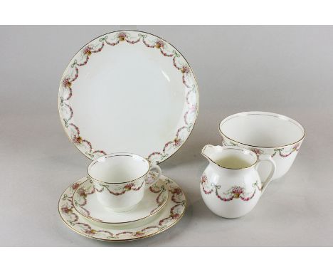 An Aynsley china part tea service, tea cups, twelve saucers, side plates, jug, bowl and plate, decorated with swags of roses