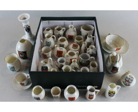 A collection of Goss and other crested china including jugs, pots, candlestick and two cups and saucers