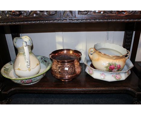 An art nouveau copper jardiniere, a ceramic jardiniere, two wash bowls and a Victorian water jug