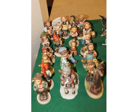 Goebel, a collection of nineteen porcelain figures of children in various pursuits and a Hummel figurine advertising plaque