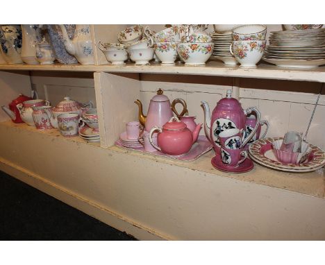 A collection of various pink and white tea ware to include a part coffee set decorated with silhouetted dancers and lovers, a