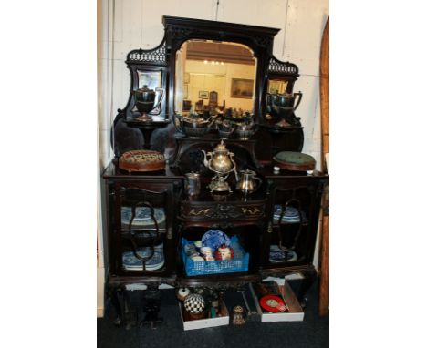 A late Victorian mahogany display cabinet with mirror and open shelf back and bow-front centre drawer and shelf flanked on ea