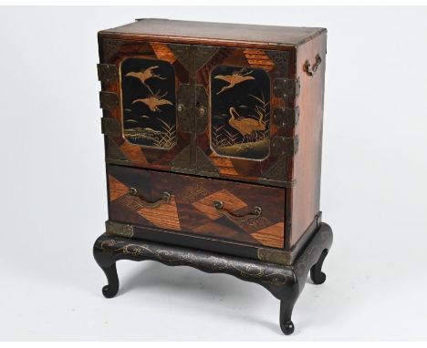 A 19th century Japanese marquetry and brass mounted table top cabinet on stand (ko-dansu) with a pair of black lacquered door