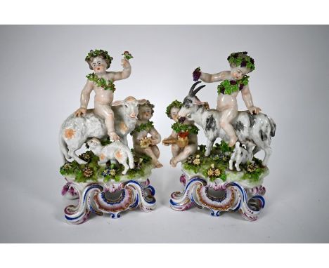 A pair of Bow porcelain groups, Bacchanalian putti carousing on goats, on scrolling bases, bearing anchor and dagger red mark