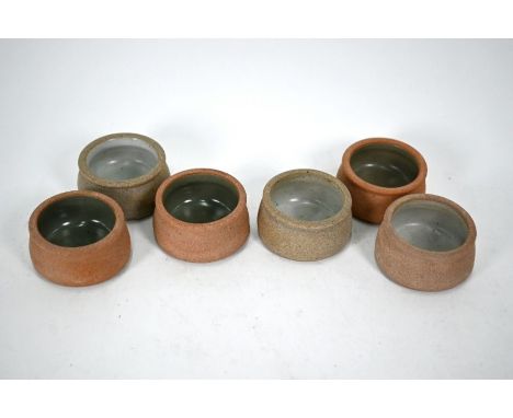 A set of six Bernard Leach (St Ives) stoneware paté pots with celadon-glazed linings, stamped L*, 6.7 cm diam