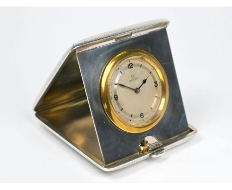 An Omega travel-clock in engine-turned silver folding pocket-case, Cohen &amp; Charles, London 1915, 8 cm wideWorking order, 