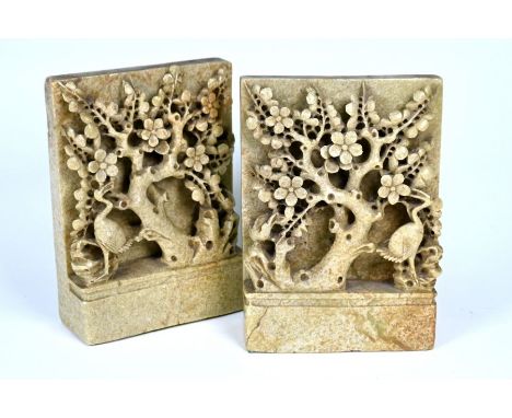 A pair of Chinese light green soapstone bookends carved with prunus and birds, 15 cm w x 6 cm d 20 cm h&nbsp;