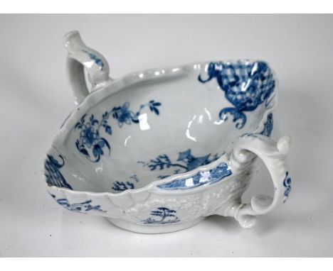 A First Period Worcester blue and white two-handled sauce boat with painted chinoiserie landscapes, floral and diaper decorat