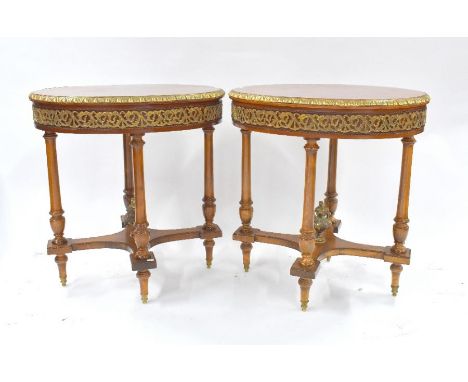 A pair of brass-mounted oval kingwood lamp tables, the tops with starburst design raised on four turned supports united by sh