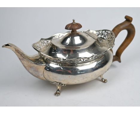 A Sheraton Revival silver teapot of squat oval form with pierced rim, on scroll feet, Mappin &amp; Webb, Birmingham 1913, 15.