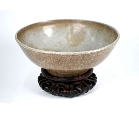 A 19th century Chinese Ge or Guan yao type bowl covered over all with an opaque light grey glaze suffused with networks of da