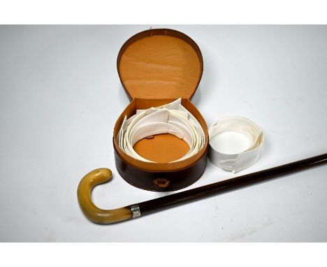 A rosewood walking stick with horn handle and silver band, London 1932 to/w a leather collar-case with contents (collars) (2)