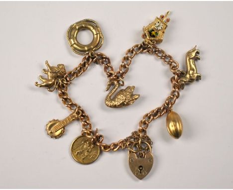 A 9ct yellow gold curb bracelet with eight charms attached including St Christopher, banjo, lion, life ring, swan, cuckoo clo