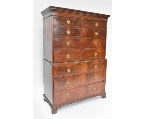 A George III mahogany chest on chest comprising two short over four long drawers with brass ring fittings, raised on bracket 