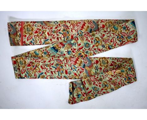 A long silk Obi, the printed decoration of phoenix amongst an abundance of flowering peonies in jewel colourways on jade gree