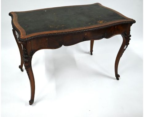 A late 19th century cross banded mahogany library desk over all round serpentine frame, the top with inset tooled leather sur