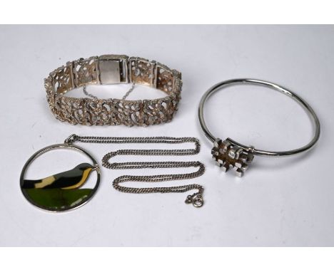 A 1970s design expanding silver bangle with brickwork motif, maker JT; a silver pierced and textured brick link bracelet and 