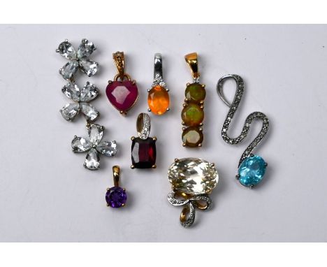 Eight various modern semi-precious gem set pendants including ruby, fire opal, blue topaz, pale citrine, amethyst, etc some d