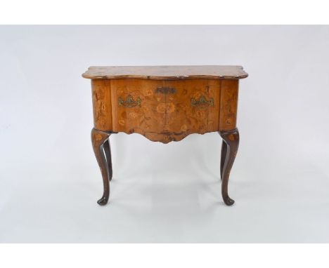An antique Dutch walnut floral marquetry serpentine commode chest, the hinge over top on a gateleg action enclosing three dee