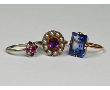 Three various rings - a rectangular dark blue topaz set in 9ct yellow gold ring, size N; a ruby and diamond cluster ring set 