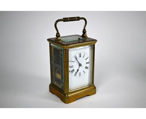 A lacquered brass 8-day carriage clock, the two train movement striking the hours and halfs on a coiled gong, the white dial 