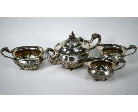 An Indian silver four-piece tea service by C Krishniah Chetty &amp; Sons, Bangalore, comprising teapot and cover with elephan