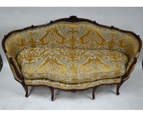 An 18th century Louis XV walnut show-framed serpentine form sofa, with traditional floral silk upholstery, raised on nine mou