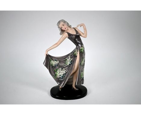 A Goldscheider pottery figure modelled by Stefan Dakon, female in floral grey dress, 32 cm; paper label at back of baseNo los