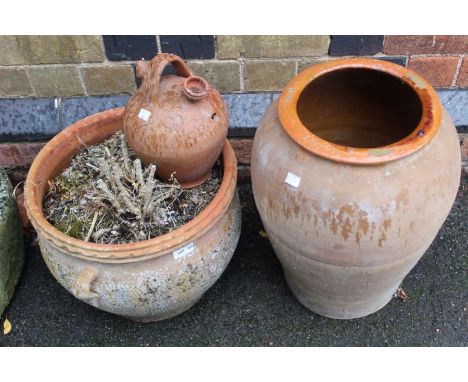 Three terracotta garden pots, Dimensions are32cm x 38cm planter, 48cm x 34cm pot, 26cm x 18cm wine pourer.