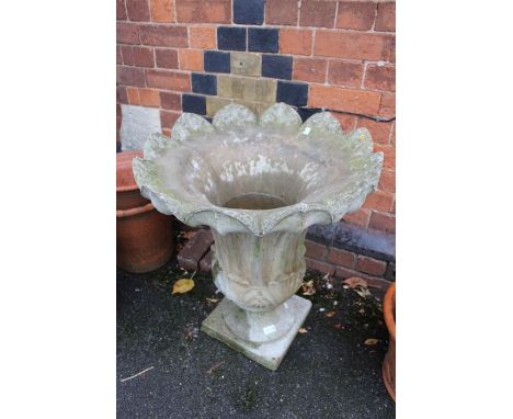 A large concrete scalloped lotus pedestal planter