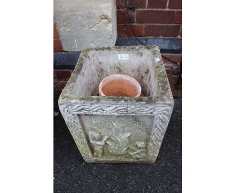 A cast concrete square formed garden planter, and two terracotta pots