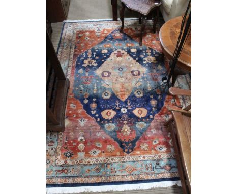 A woven woollen, aged geometric patterned floor carpet 