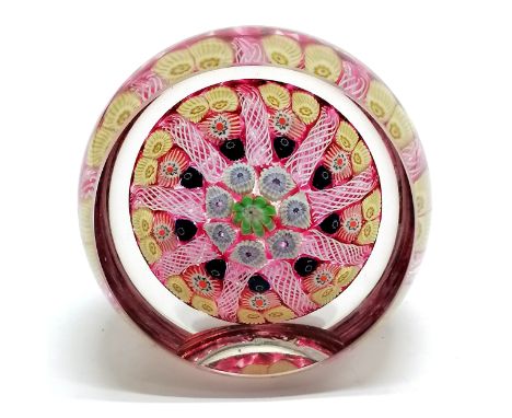 Millefiori paperweight with central cane, concentric ring &amp; 9 radial twists separating cane groups of 1-1-2 ~ has facet f