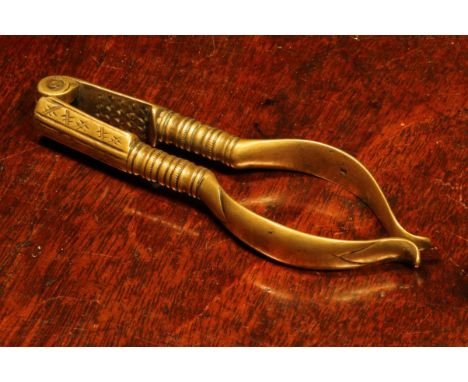 Nutcrackers - an early 18th century brass lever-action nut cracker, 11cm long, marked *J, c.1720 