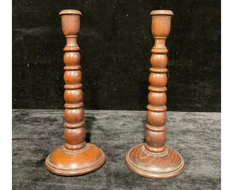 Local Interest - a pair of salvaged oak table candlesticks, campana sconces, bobbin and ring turned pillars, each base with a