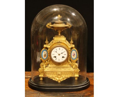 A late 19th century French gilt brass mantel clock, the white enamel dial with Roman numerals, flanked by pair of blue celest