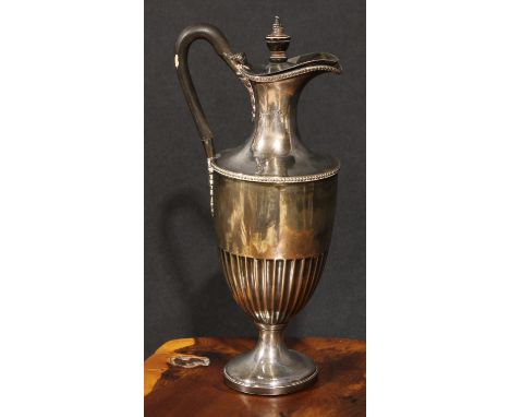A Victorian silver half-fluted pedestal ewer or claret jug, ebony handle and finial, 26cm high, London 1882, weighted base, 5