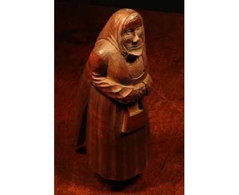 Nutcrackers - a Black Forest novelty lever-action nut cracker, carved as an elderly woman, she stands, wearing a headscarf an