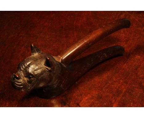 Nutcrackers - a Black Forest novelty lever-action nut cracker, carved as the head of a French bulldog, glass eyes, 23cm long,