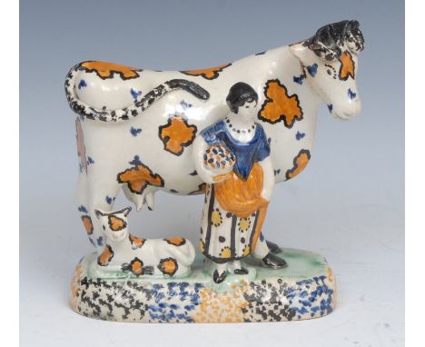 A James Emery Pottery Mexborough cow, calf and milkmaid group, decorated in the typical Pratt ware/Pearlware manner, the cow 