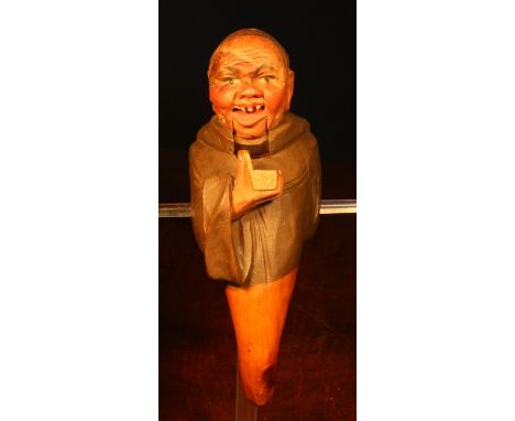 Nutcrackers - a Black Forest novelty lever-action nut cracker, carved and painted as a monk holding a snuff box, 21cm long, e