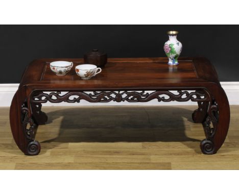 A Chinese hardwood low tea or kang table, panelled top above a deep frieze pierced and carved with scrolls and lotus, C-scrol