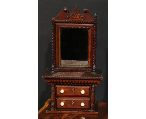 A 19th century tramp art miniature dressing chest, shaped cresting above a rectangular mirror, within geometric borders, the 
