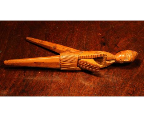 Nutcrackers - an early 18th century French boxwood figural lever-action nut cracker, of slender proportions, 21cm long, Alsac