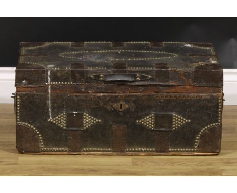 An 18th century leather-clad travelling trunk, hinged cover, steel bound and outlined with brass studded borders, 27cm high, 