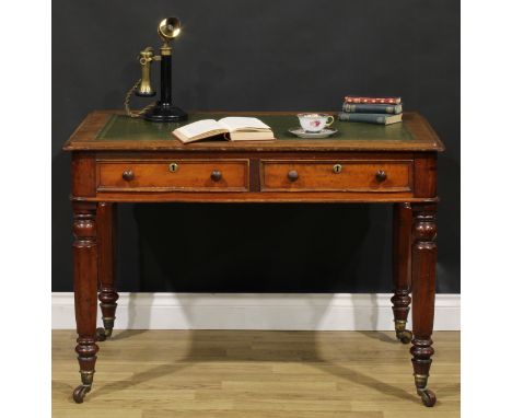 A Victorian mahogany rounded rectangular writing table, tooled and gilt writing surface, drawers to frieze, turned and panell