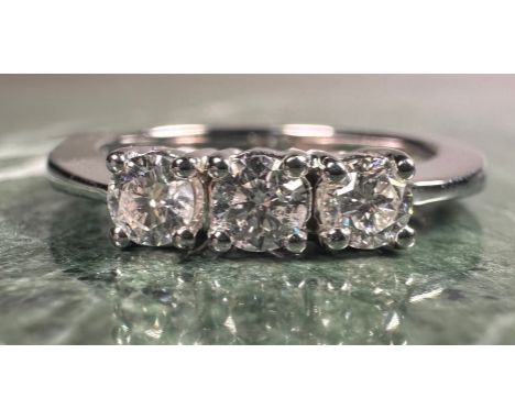A diamond ring, set with three round brilliant certified diamonds, colour F-G, clarity SI2, total diamond weight 0.50ct, 18ct