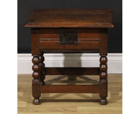 An 18th century oak box stool, hinged top enclosing a compartmented interior, bobbin-turned and blocked supports, 43.5cm high