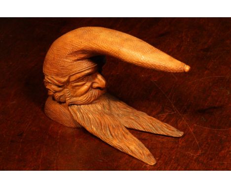 Nutcrackers - a Black Forest novelty table top lever-action nut cracker, carved as the head of a gnome, 15cm long, c.1870 